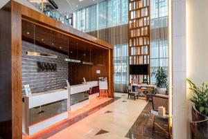 a lobby of a building with a waiting area at Ramada by Wyndham Dubai Barsha Heights in Dubai
