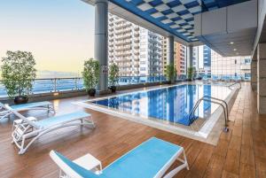 a pool on the top of a building with a view at Ramada by Wyndham Dubai Barsha Heights in Dubai