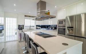 a white kitchen with a counter and a refrigerator at Thelifehouse in Marbella
