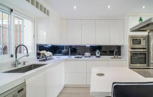 a white kitchen with white cabinets and a sink at Thelifehouse in Marbella