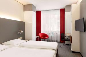 Postel nebo postele na pokoji v ubytování Vienna House Easy by Wyndham Stuttgart