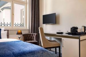 Televízia a/alebo spoločenská miestnosť v ubytovaní Wyndham Grand Krakow Old Town