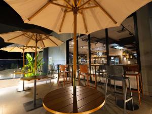 巴拉杜加薩斯的住宿－ibis Barra do Garcas，餐厅内一张桌子、椅子和遮阳伞