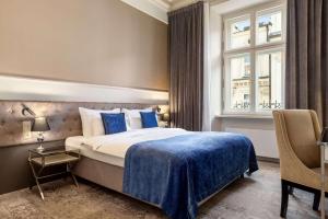 Posteľ alebo postele v izbe v ubytovaní Wyndham Grand Krakow Old Town