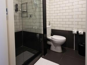 a bathroom with a toilet and a shower at ibis Barra do Garcas in Barra do Garças