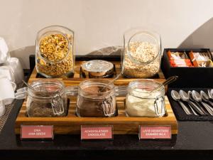 a table with three containers of oatmeal and other food items at ibis Barra do Garcas in Barra do Garças