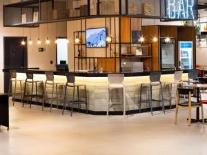a bar in a restaurant with stools at ibis Barra do Garcas in Barra do Garças