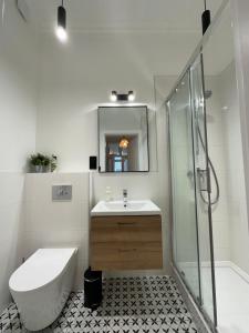 a bathroom with a sink toilet and a shower at Kamienica Ogrodowa Rooms in Sopot