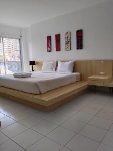 a bedroom with a large bed in a room at Urban Patong Residence in Patong Beach