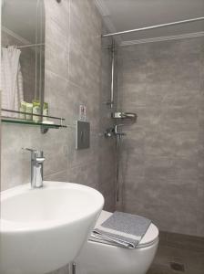 a bathroom with a white sink and a toilet at Diamanti Studios in Skala Kallonis