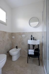 a bathroom with a sink and a toilet and a mirror at Sopramare Resort in Piano di Sorrento