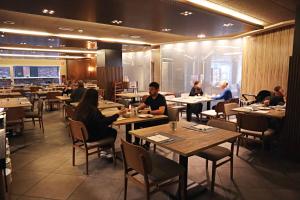 a group of people sitting at tables in a restaurant at Yomo Mola Park in Andorra la Vella