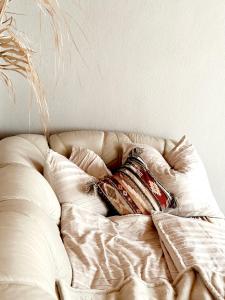 a white couch with a pillow on top of it at Wohnung in Graz - city center in Graz