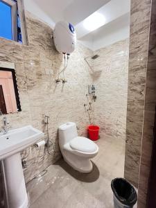 a bathroom with a toilet and a sink at Little Sikkim Inn in Gangtok