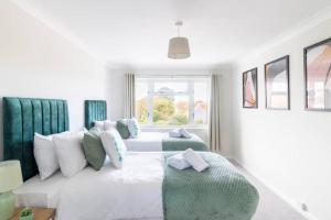 um quarto com 2 camas brancas e uma janela em WOW! SeaView Beach Apartment Sleeps 6-Free Parking em Bournemouth