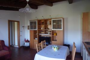 a living room with a table and a kitchen at Casa Tre Pini in Serravalle Pistoiese