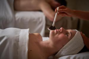 a man laying in bed with a brush in his mouth at The Nici in Bournemouth