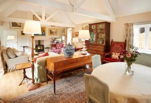 a living room with a bed and a table at Coral Cottage at Castle Howard in York