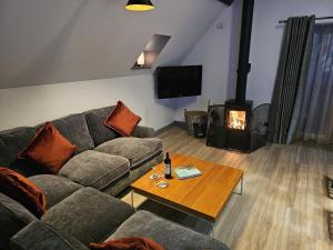 a living room with a couch and a wood stove at Melfort Pier & Harbour Resort in Kilmelfort