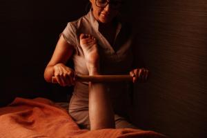 a woman sitting on a bed holding a stick at The Nici in Bournemouth