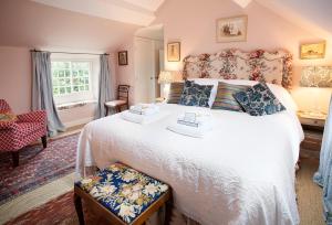 a bedroom with a large bed and a window at Coral Cottage at Castle Howard in York
