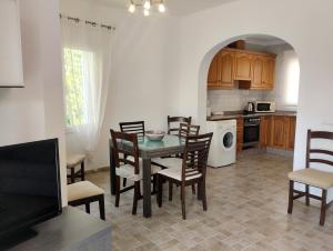 a kitchen and dining room with a table and chairs at Villas Benicadims - BTB in Beniarbeig