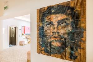 a painting of a man on a wall in a room at The Nici in Bournemouth