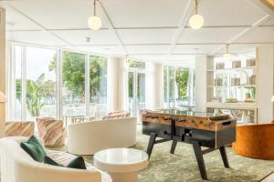 a living room with a pool table and chairs at The Nici in Bournemouth