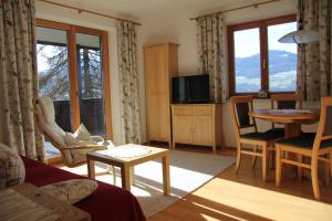 a living room with a couch and a table at Reiterhof in Westendorf