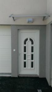 a white door with a window on a house at Apartments Foco in Sarajevo