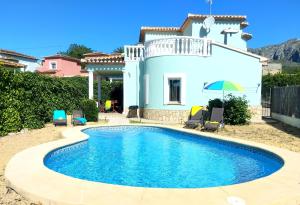 a villa with a swimming pool in front of a house at Villas Benicadims - BTB in Beniarbeig