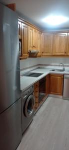 a kitchen with a stainless steel refrigerator and a dishwasher at Vivienda Benasque Ibonet in Benasque