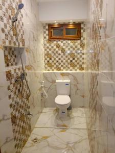 a bathroom with a toilet and a shower at Aourir's new appartement in Agadir