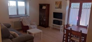 a living room with a couch and a table at Vivienda Benasque Ibonet in Benasque