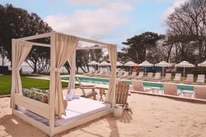 a bed on the sand next to a pool at The Nici in Bournemouth
