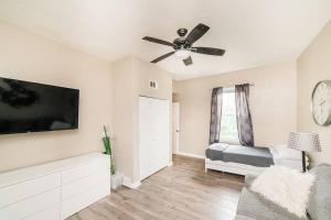a living room with a ceiling fan and a tv at Comfortable and Walkable - Off-Street Parking in Pittsburgh