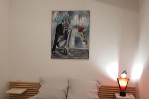 a painting of a woman with a rose on a wall at Le Patio in Saintes-Maries-de-la-Mer