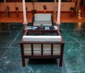 a coffee table with a chair on top of a floor at Mango Hill La Serene Puducherry in Pūrnānkuppam