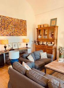 a living room with a couch and a table at Villa Lavanda by Época Suites in El Castillo de las Guardas