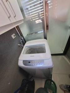 a toaster sitting in a bathroom next to a refrigerator at Dpto Cerca de Strip Center Oasis in Calama