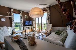 a living room with a couch and a table at Apartament Trap in Karwia