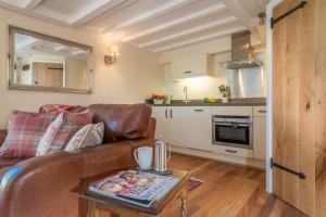 a living room with a couch and a table at Melin-Byrdir in Dyffryn +18 photos