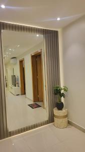 a large mirror in a room with a potted plant at شقة متكاملة VIP غرفتين وجلسة خارجية in Riyadh