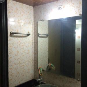 a bathroom with a large mirror and a sink at Luxurious 2BHK bunglow with garden in Solapur