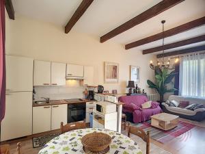 a kitchen and a living room with a table at Appartement Lamalou-les-Bains, 2 pièces, 2 personnes - FR-1-451-31 in Lamalou-les-Bains