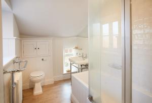 a bathroom with a toilet and a sink at Chanting Hill Farmhouse at Castle Howard in Welburn
