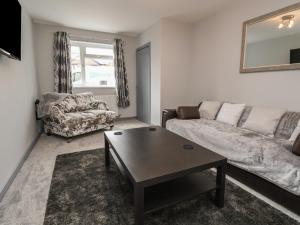 a living room with a couch and a coffee table at Woodside in Wrexham