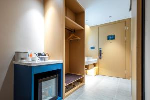 a room with a fireplace and a bathroom at Atour Hotel Meizhou West Station R&F Center in Meizhou