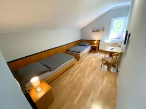 Kleines Zimmer mit 2 Betten und einem Schreibtisch. in der Unterkunft Stadtgarten Gotha in Gotha