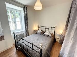 a bedroom with a black bed with two pillows at Appartement Granville, 2 pièces, 2 personnes - FR-1-361-330 in Granville